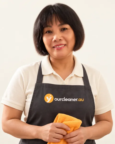 Your Cleaner team member in branded uniform — AI-restyled from her supplied portrait